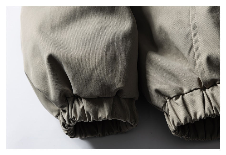 Close-up of a taupe garment with gathered elastic cuffs.