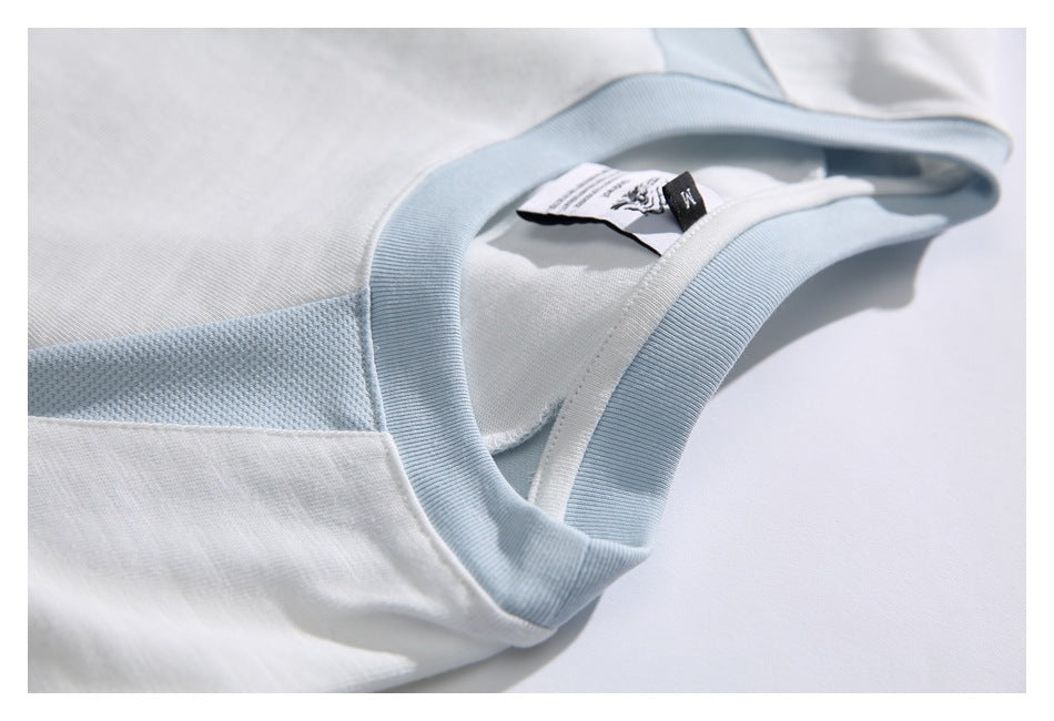 Close-up of a white shirt neckline with pale blue ribbed trim and a textured blue shoulder panel.
