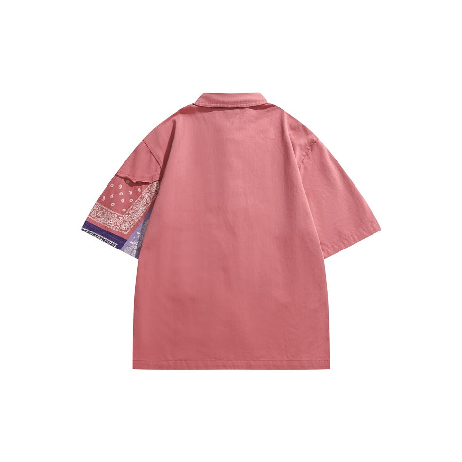 Back view of a pink short-sleeve collared shirt with a pink and lavender bandana-print panel on one sleeve.