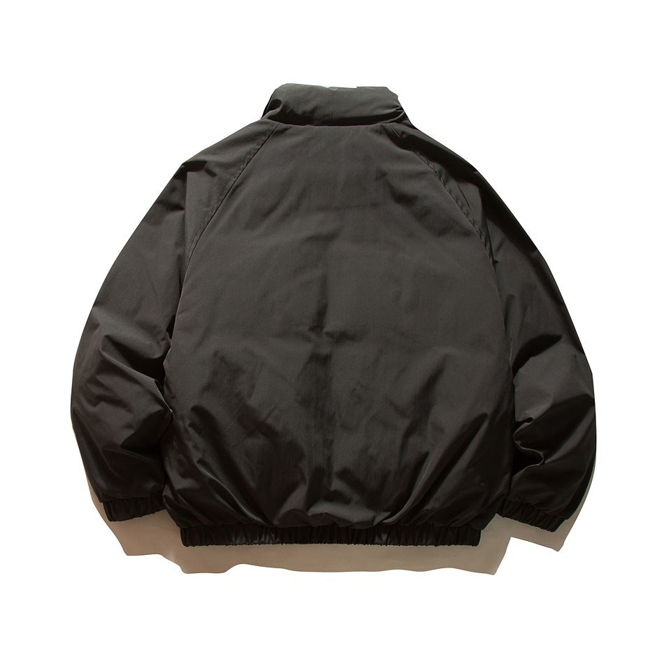 Back view of a black jacket with a tall collar, long sleeves and gathered cuffs and hem.