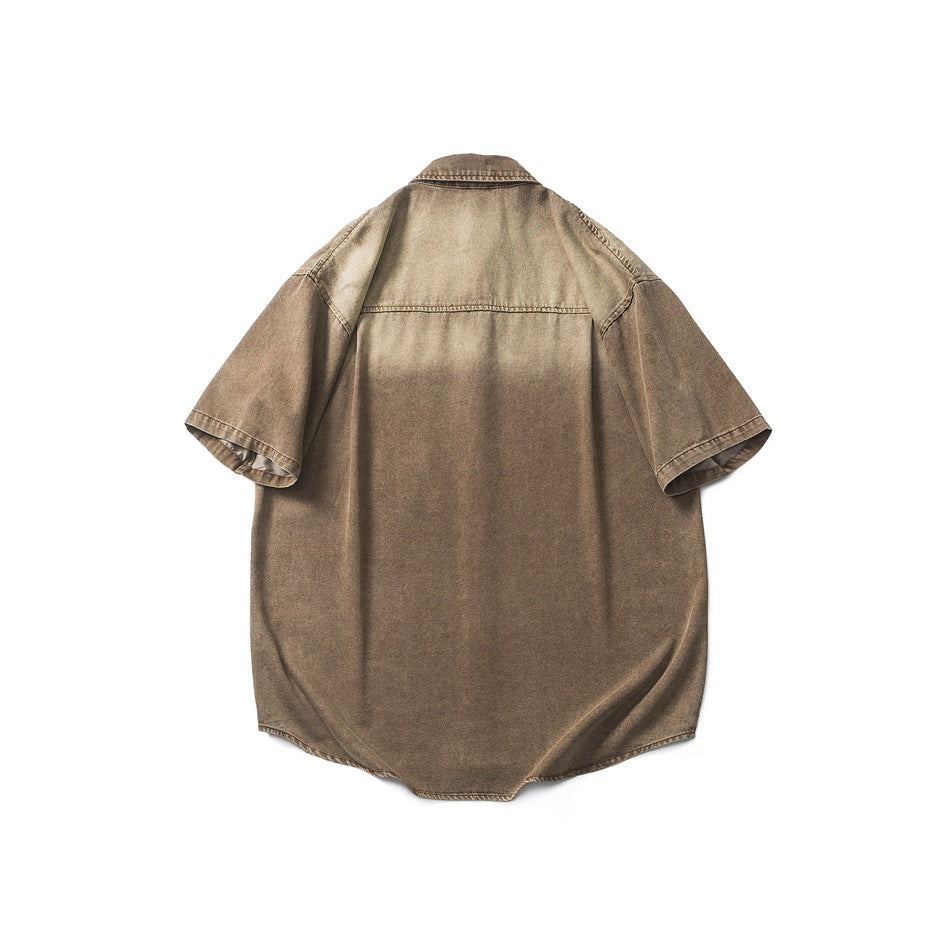 Back view of washed brown-tan short-sleeve denim-look shirt with yoke seam and faded shading