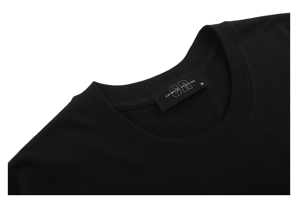Close-up of a black T-shirt’s crew neck and inner brand label against a white background.