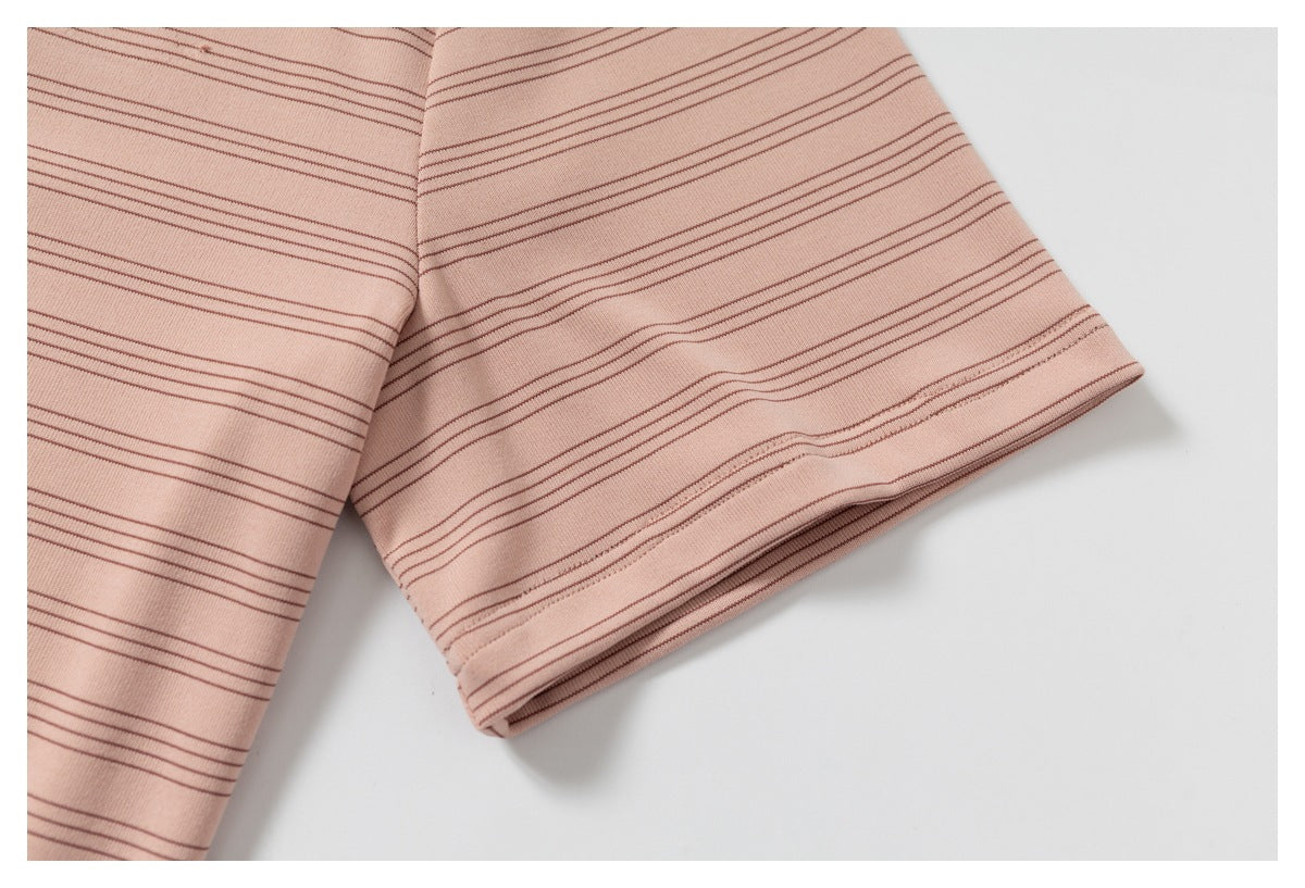 Close-up of a short sleeve on a pink garment with thin brown horizontal stripes.