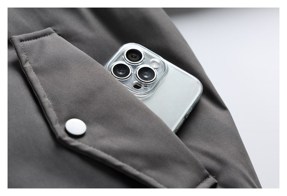 A phone tucked into a charcoal jacket's snap-flap pocket.