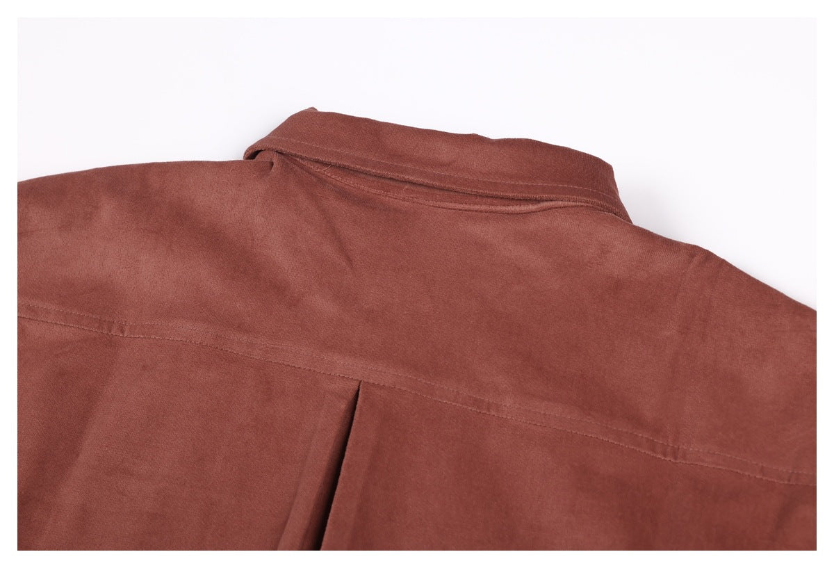 Close-up of the rust-brown shirt's back, showing its collar, shoulder seam and pleat.