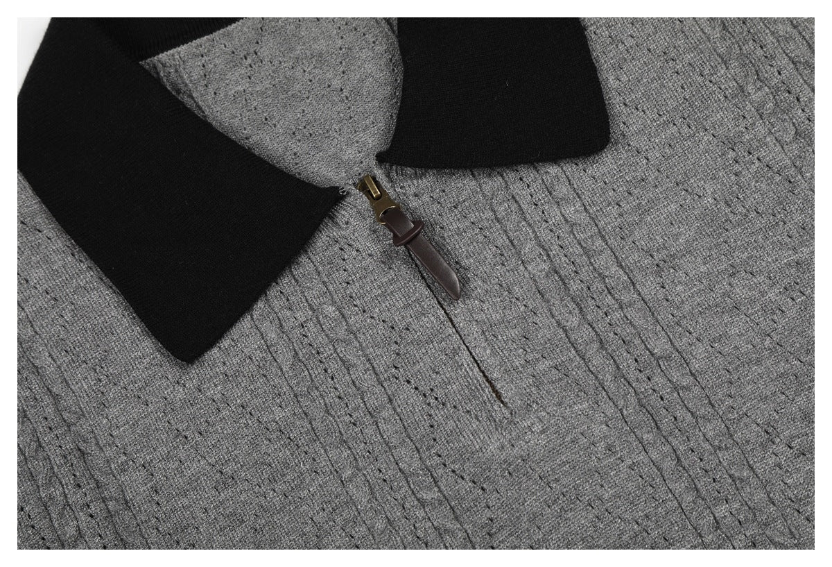 Close-up of the black collar, short zipper, and textured gray knit on the top's front.
