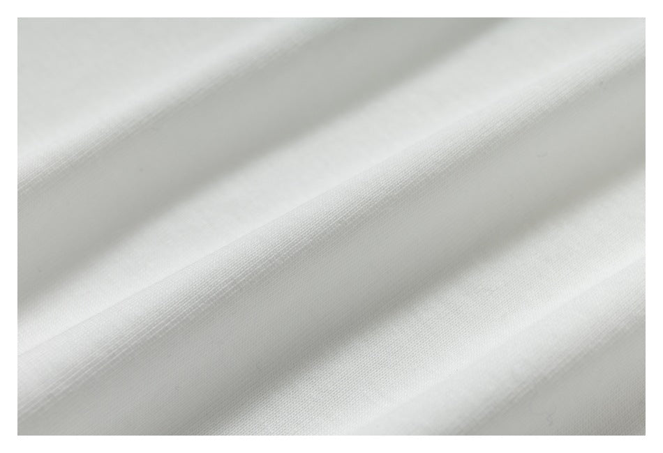 Extreme close-up of the white garment's textured fabric.