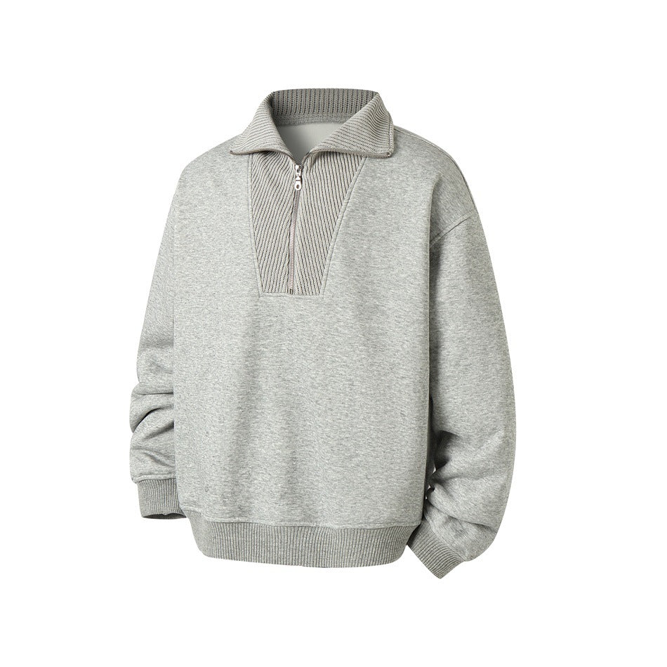 Heather gray half-zip sweatshirt with ribbed collar, angled front view showing zipper and ribbed hem and cuffs