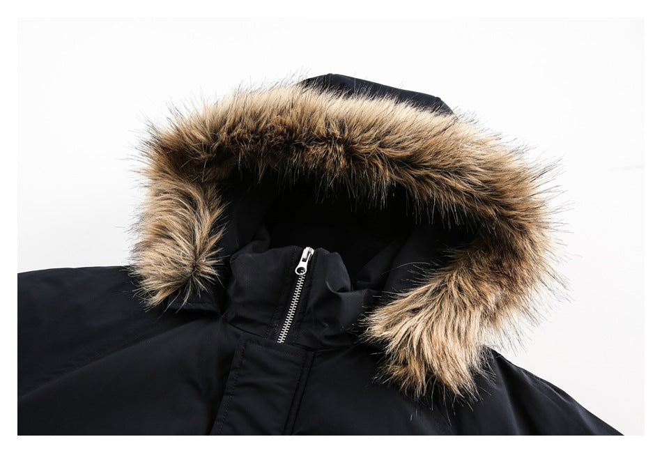 Close-up of a black coat hood edged with thick brown and tan fur trim.