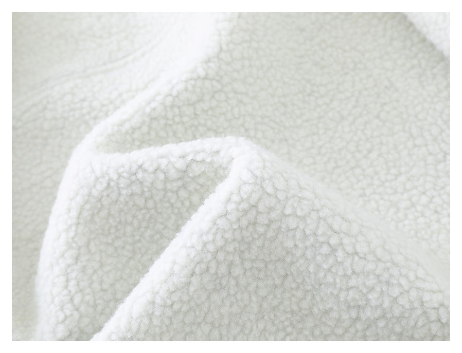 Close-up showing the thick, fluffy texture of white fleece folded over itself.