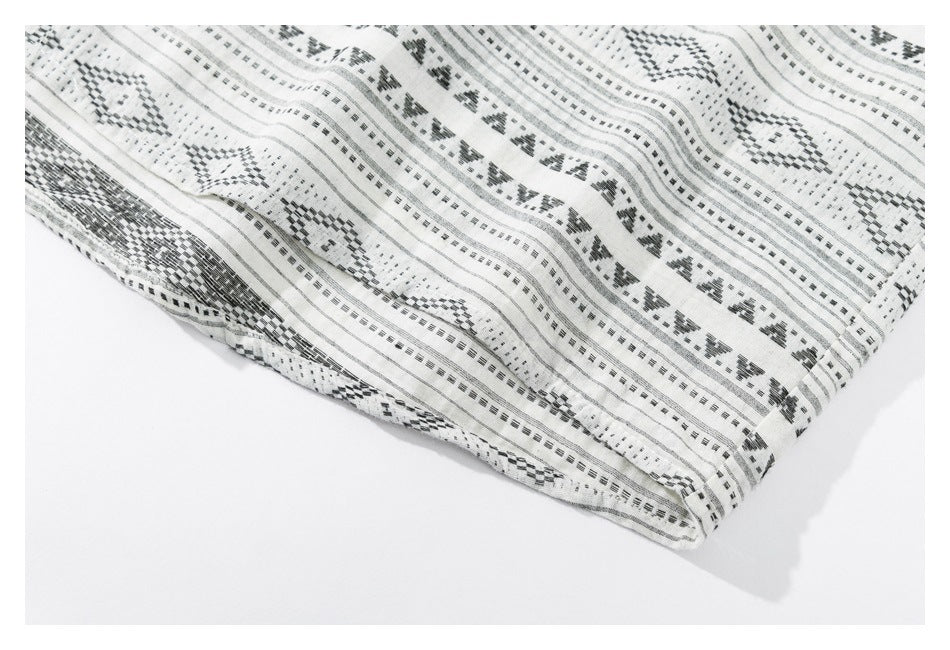 Close-up of the shirt's patterned fabric and stitched hem edge.