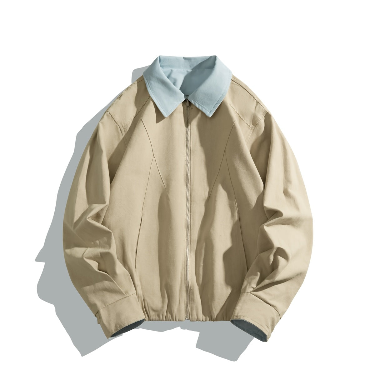Front view of a beige zip-front jacket with a pale blue pointed collar and cuffs.