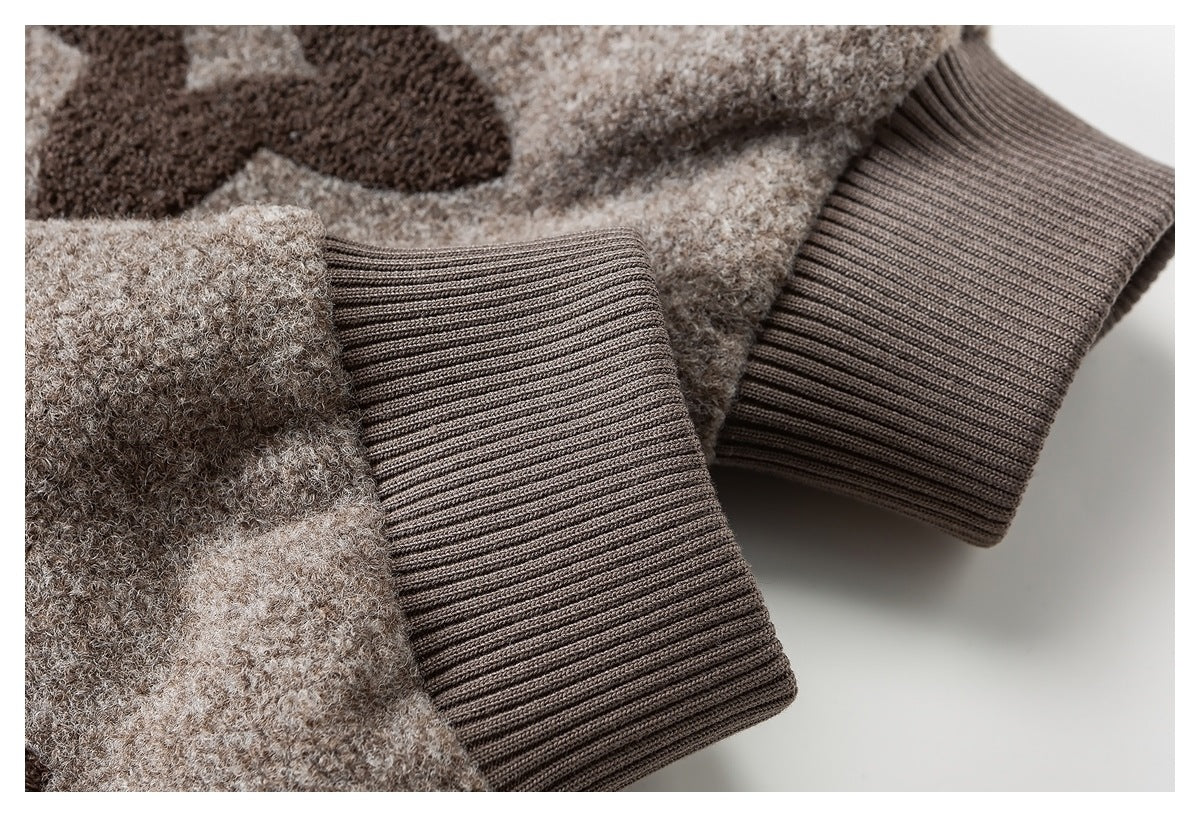 Close-up of the beige knit garment's wide ribbed brown cuffs.