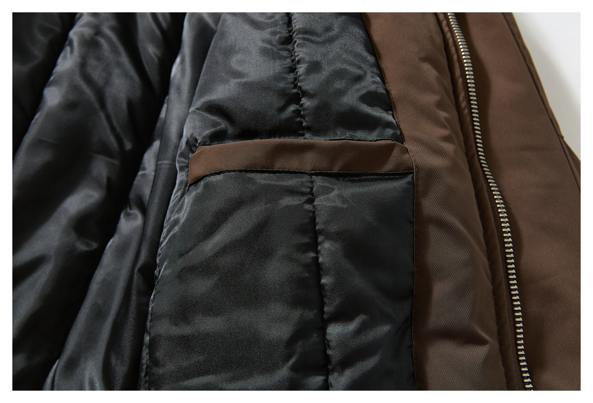 Close-up of the jacket's black interior lining and pocket beside the brown outer fabric and zipper.