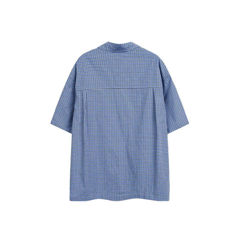 Back view of blue small-check short-sleeve shirt showing yoke seam and center pleat