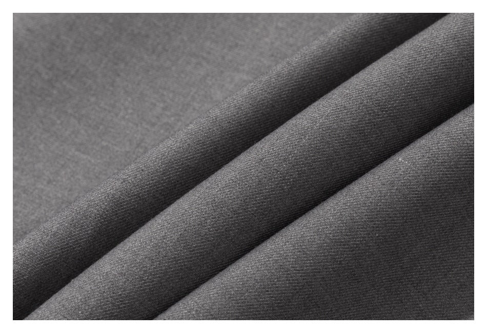 Extreme close-up of gray shirt fabric folded into soft ridges.