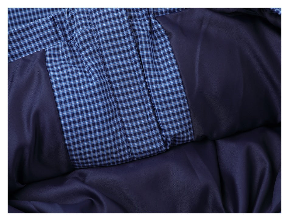 Close-up of a dark navy garment with a blue-and-black checked fabric panel.