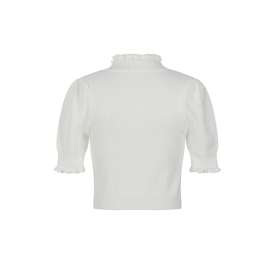Back view of off-white cropped knit top with ruffled neckline, puff sleeves and ribbed hem