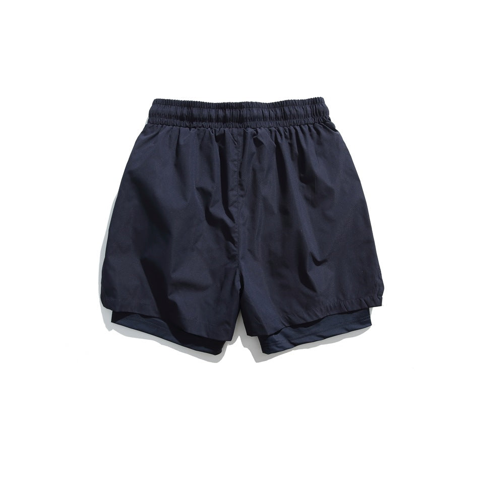 Back view of dark navy shorts with an elastic waistband and layered hems.