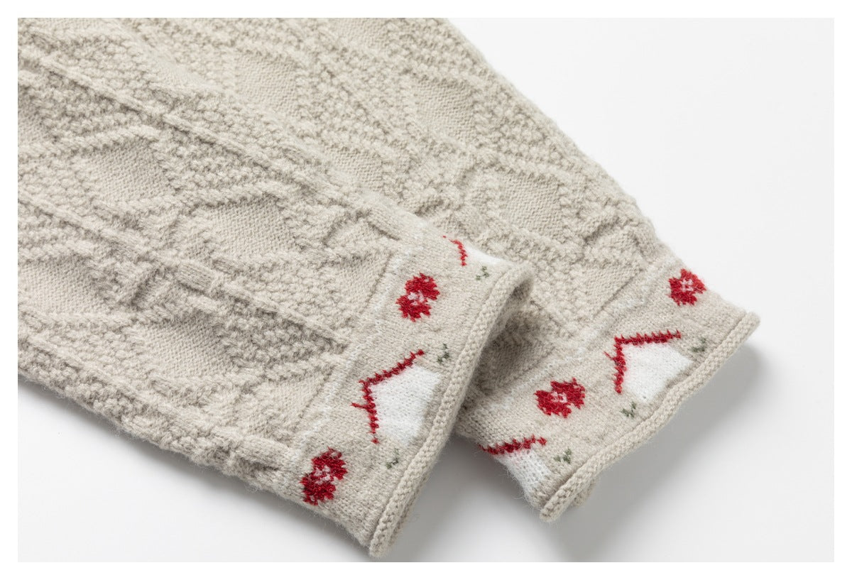 Close-up of two cream knit cuffs with red, green, and white patterned borders.