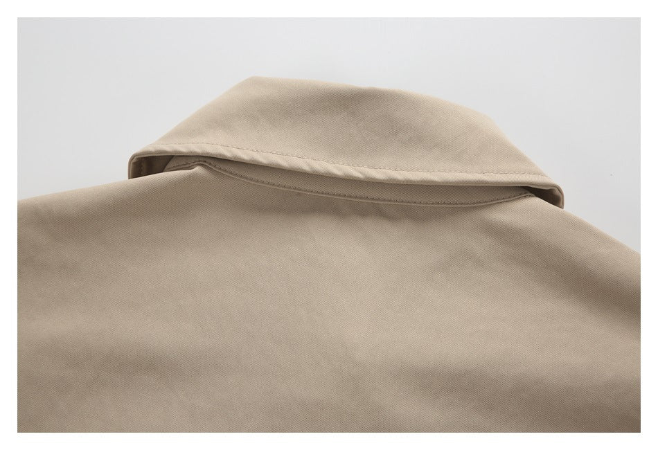 Close-up of a beige garment collar and upper back with visible stitching.