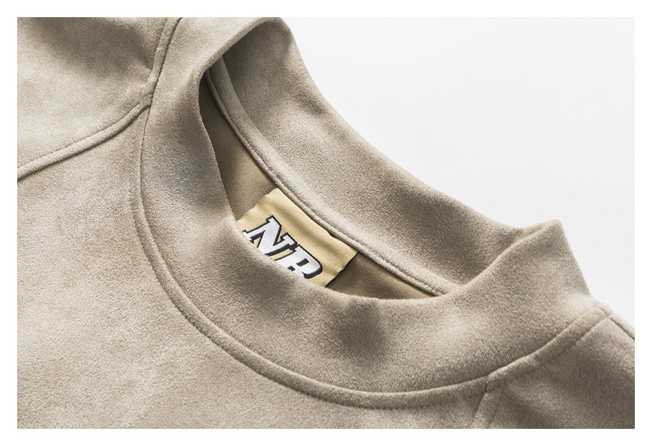 Close-up of the taupe sweatshirt’s crew neckline and inside neck label.