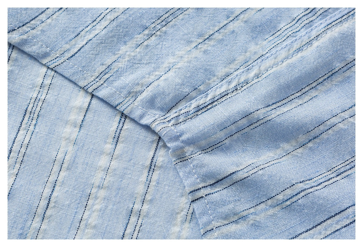 Folded pale blue fabric with narrow navy stripes and stitched seams.