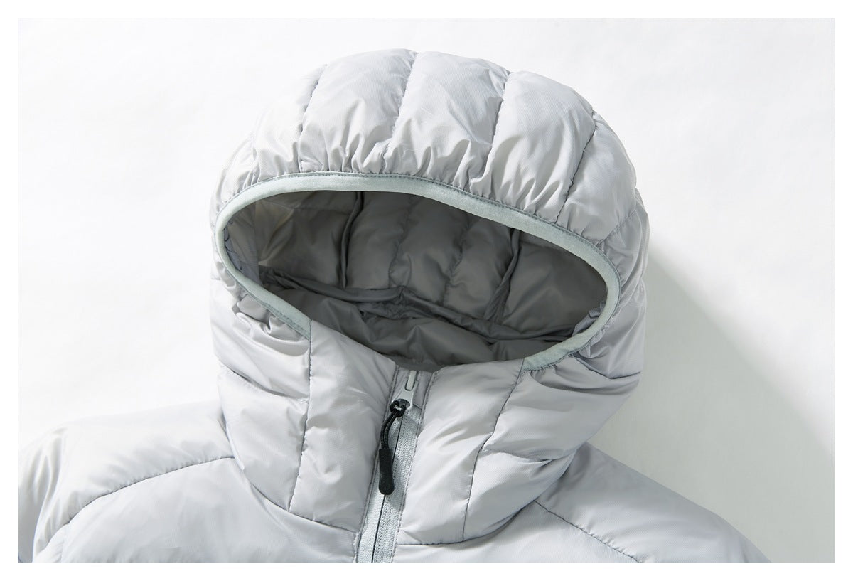 Close-up of the light gray puffer jacket's hood, showing its padded lining, trim, and front zipper.