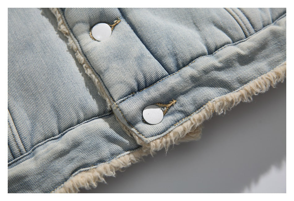 Close-up of the denim jacket hem with silver snaps and cream fuzzy lining exposed along the edge.