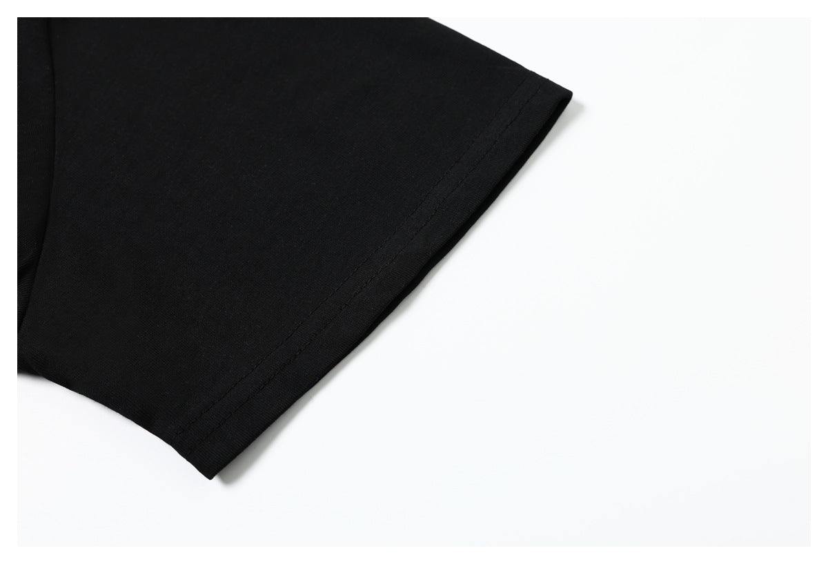 Close-up of the plain black T-shirt sleeve and stitched hem.