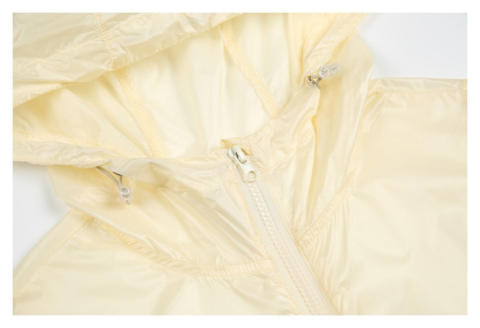 Close-up of a pale cream jacket showing its hood, drawcords and front zipper.