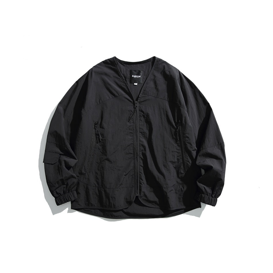 Black V-neck zip-front jacket with crinkled texture, zippered side pockets and elasticized cuffs, flat lay front view