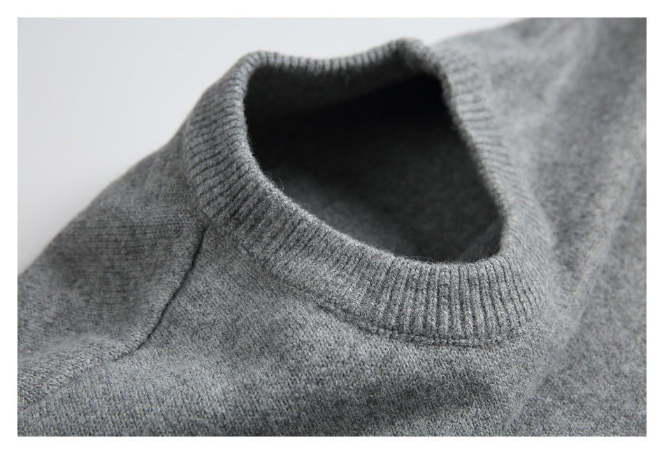 Close-up of the gray sweater's ribbed crew neck, showing the inside of the neckline.