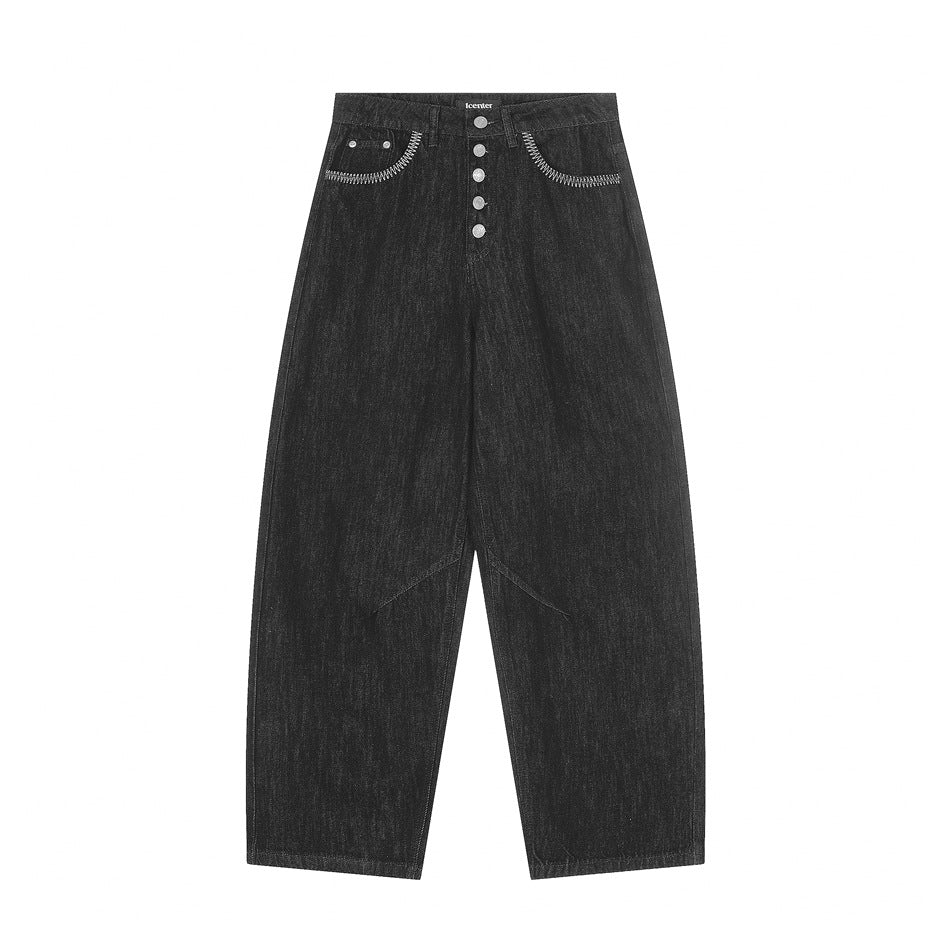 Front flat lay of black washed-denim wide-leg jeans with five-button fly and embroidered pocket openings