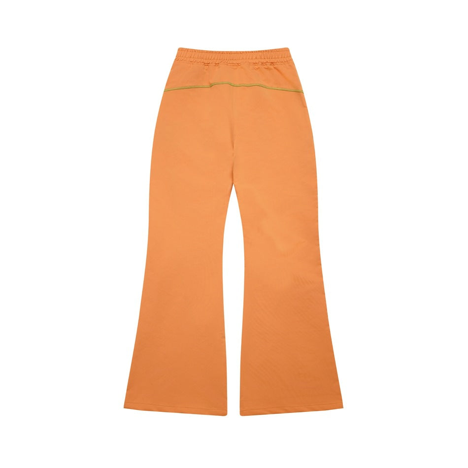 Full view of orange flared trousers with an elastic waistband and a curved contrast seam across the back.
