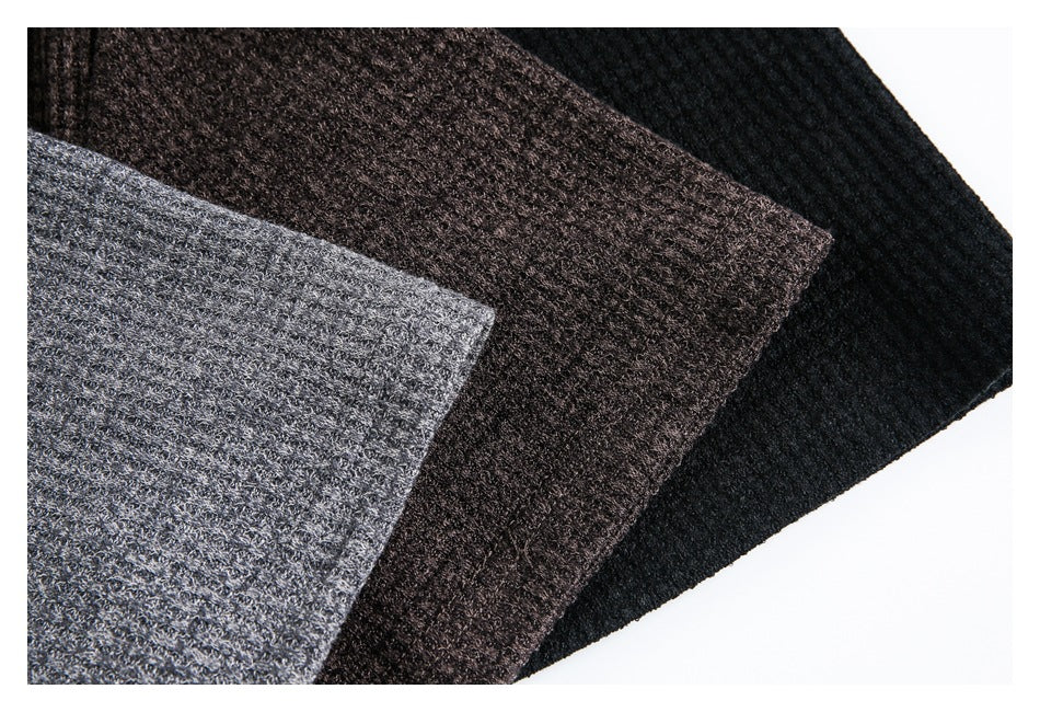 Close-up of textured fabric from gray, dark brown, and black polo shirts arranged side by side.