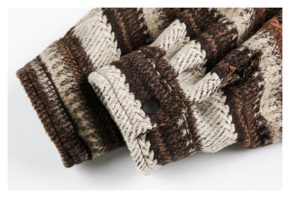 Close-up of a plaid cuff with a black snap button and stitched edges.