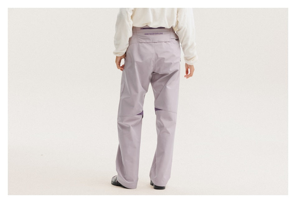 Rear view of a model wearing light lavender trousers with a wide waistband and purple knee accents.