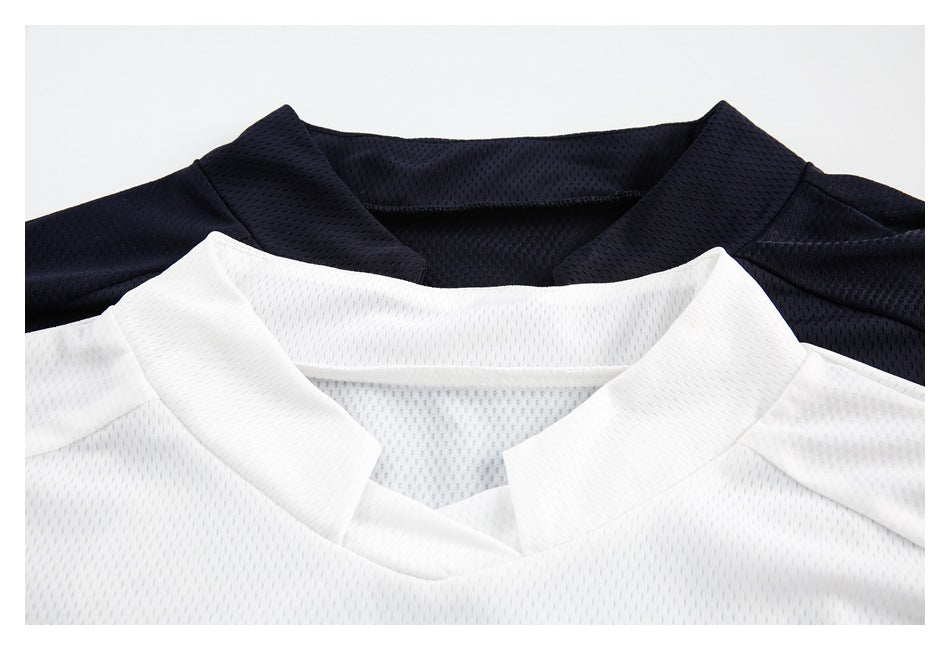 Close-up of white and navy jerseys showing their perforated fabric and short stand collars.