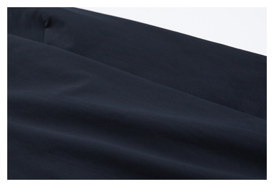 Close-up of smooth, plain dark navy garment fabric.