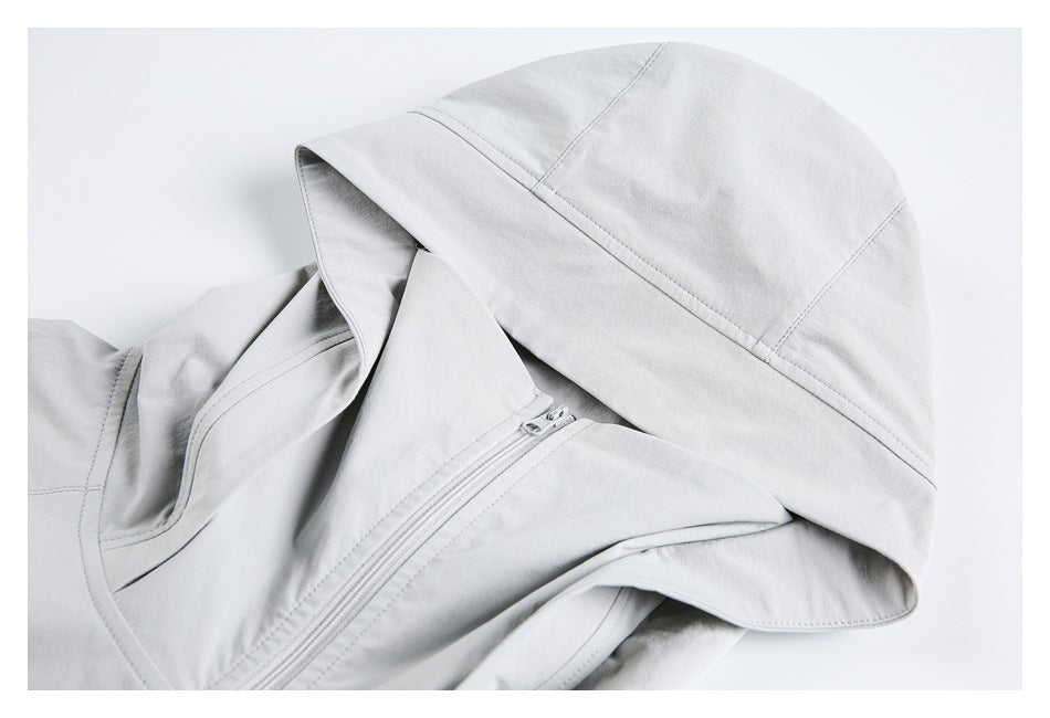 Close-up of a light gray jacket hood, collar, and front zipper.