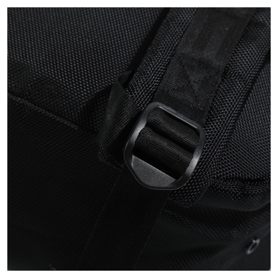 Close-up of a black adjustable strap threaded through a plastic buckle.