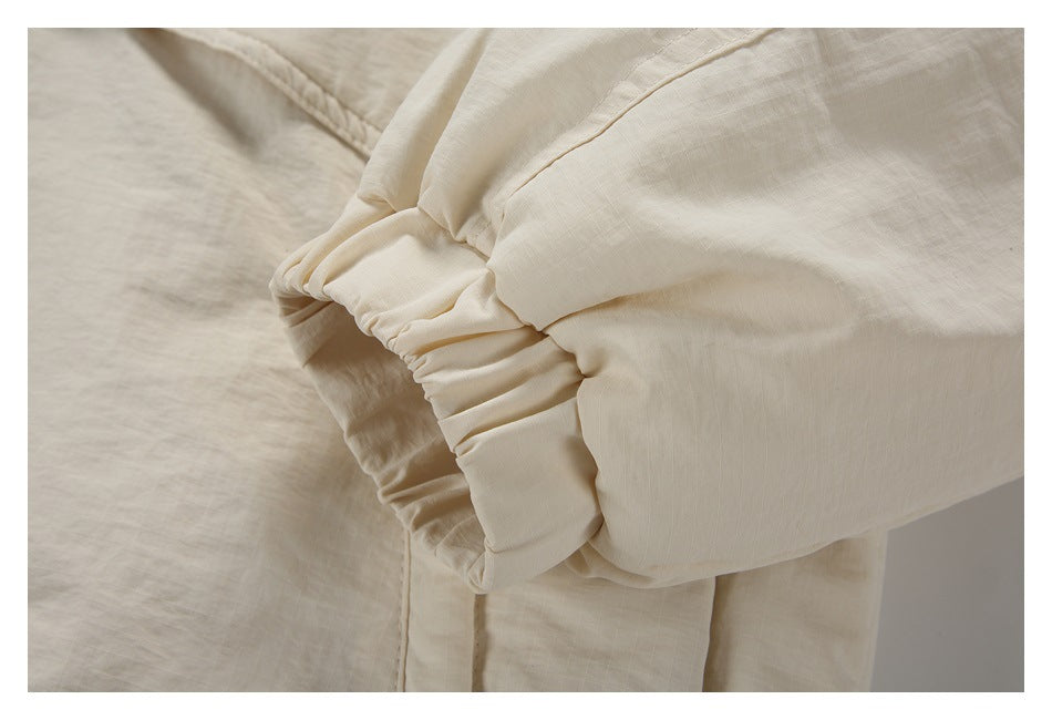 Close-up of the cream jacket sleeve with a gathered elastic cuff.