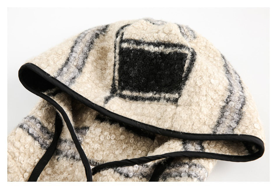 Close-up of the striped jacket’s hood, showing a black rectangular patch and black edging.