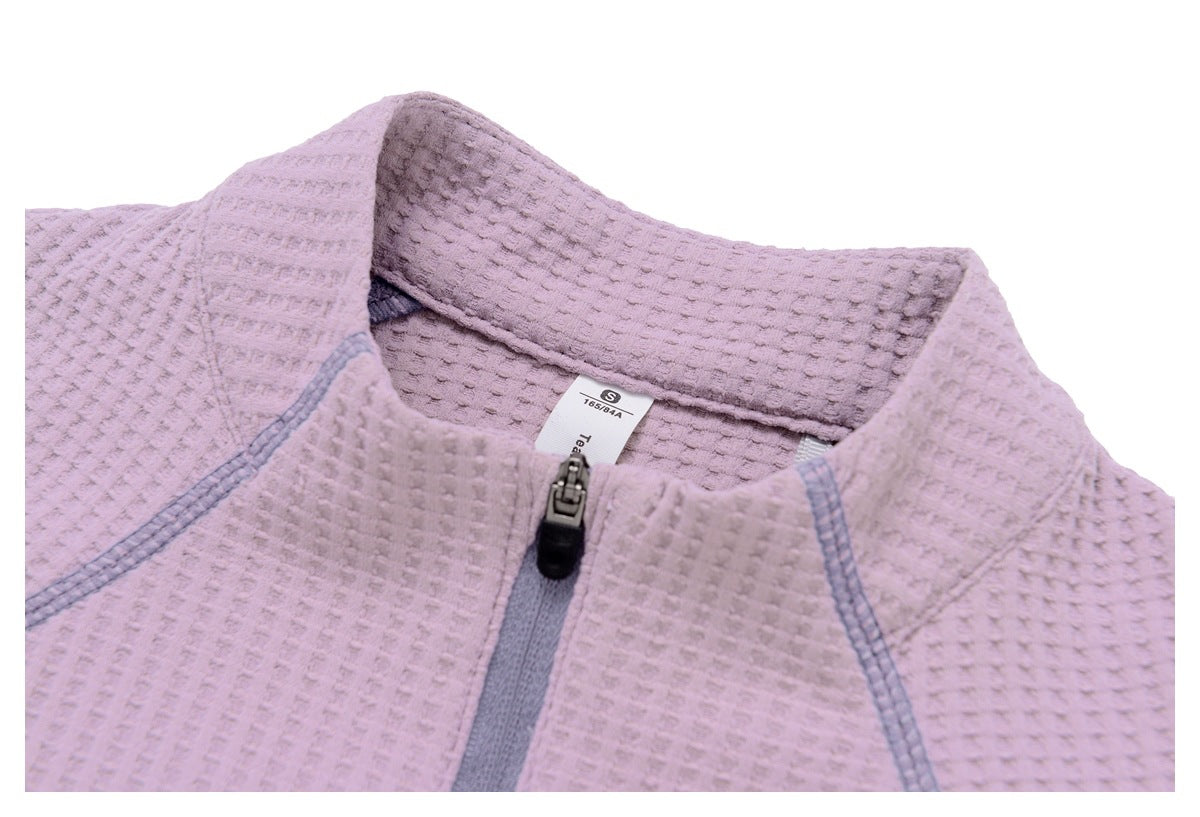 Close-up of a mauve textured jacket collar and gray center zipper, with a size tag inside.