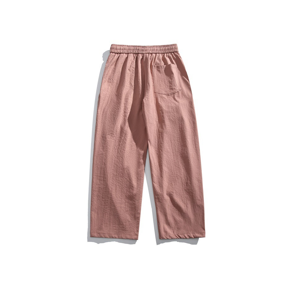 Back view of dusty rose wide-leg pants with an elastic waistband and a single back pocket.