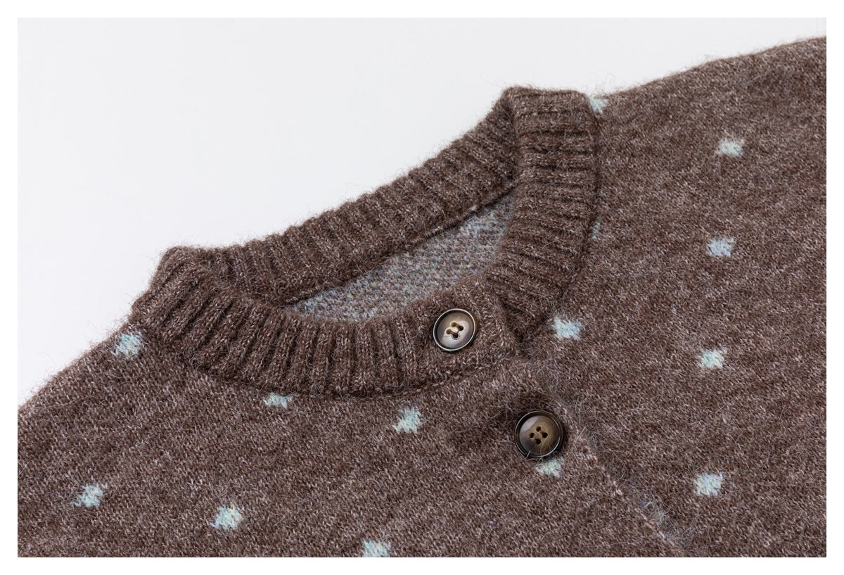 Close-up of a brown knit cardigan neckline with pale blue dots, ribbed trim, and two dark buttons.