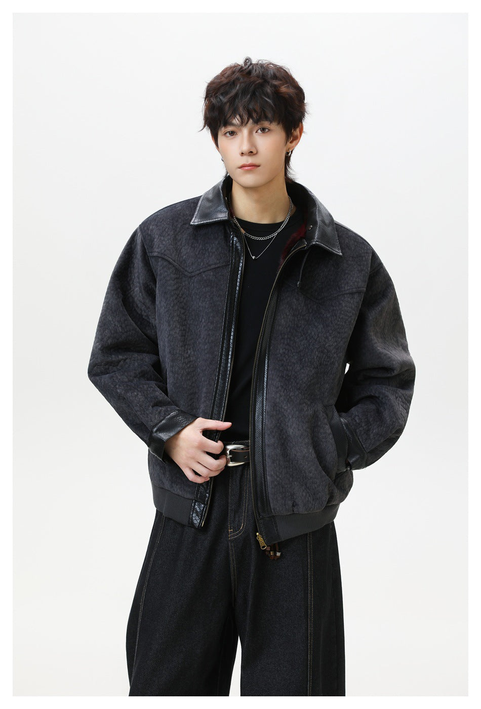 Front view of a model wearing a dark charcoal textured zip jacket with black trim.