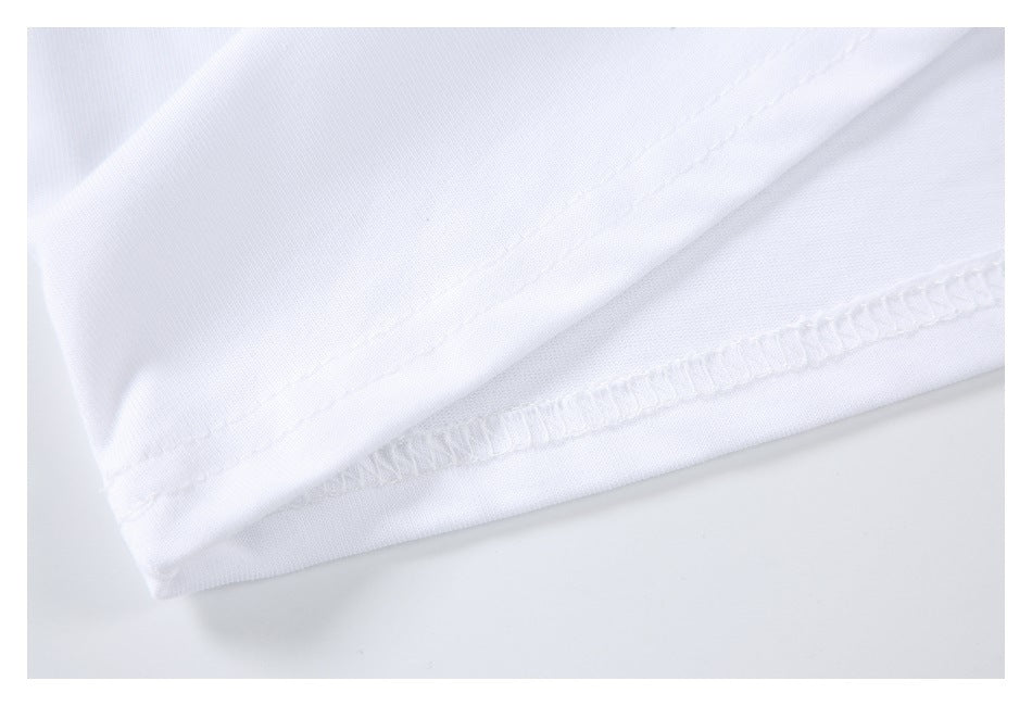 Close-up of white fabric seams and overlock stitching along a garment edge.