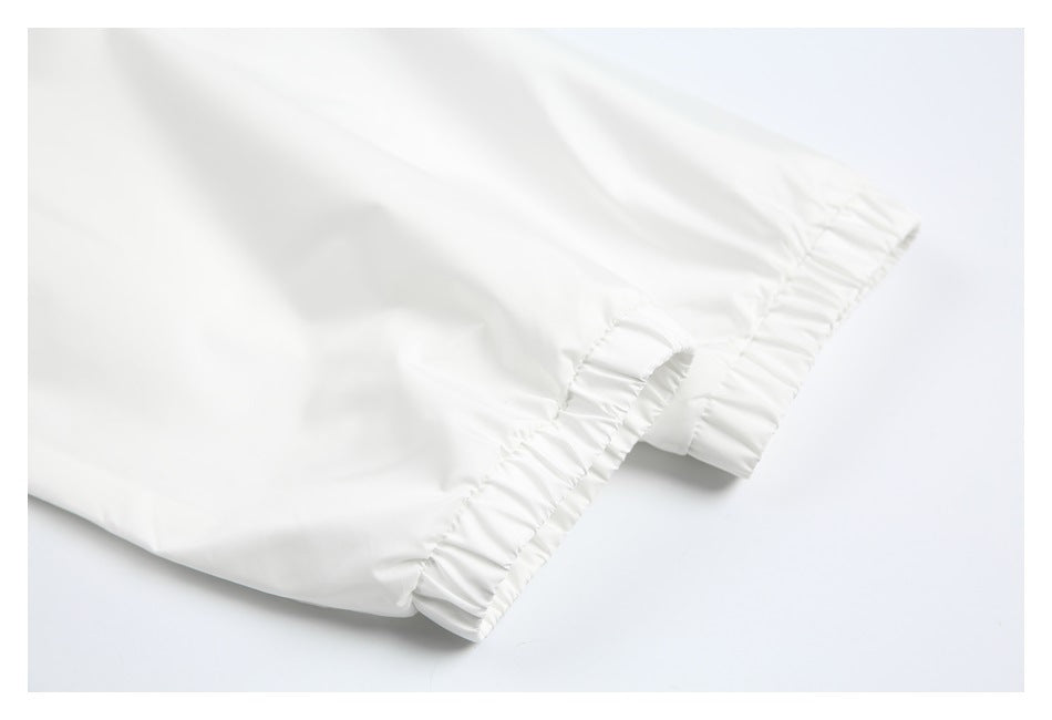 Close-up of a white garment sleeve ending in a gathered elastic cuff.